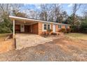 Brick ranch house with covered carport, and mature trees at 304 Shady Ln, Norwood, NC 28128