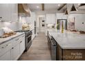 Spacious kitchen featuring white cabinets, marble countertops, and a large island at 7120 Fowley Rd # 331, Charlotte, NC 28269