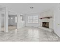 Living room with fireplace and tile flooring at 800 Peachtree Rd, Charlotte, NC 28216