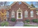 Elegant front entry with arched doorway and brick facade at 9302 Brown Gelly Dr, Huntersville, NC 28078