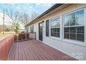 Inviting front porch with red wooden railing at 104 Barbee Sw Rd, Concord, NC 28027