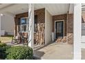 Brick front porch with rocking chairs and a welcoming sign at 14132 Green Birch Dr, Pineville, NC 28134