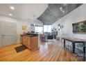 Open concept dining area with hardwood floors and city views at 210 N Church St # 1213, Charlotte, NC 28202