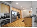 Modern kitchen with stainless steel appliances and light wood cabinets at 210 N Church St # 1213, Charlotte, NC 28202