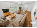 Virtually staged living room featuring hardwood floors and neutral furniture at 9316 Joines Dr, Matthews, NC 28105