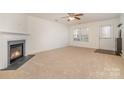 Living room with fireplace, carpet, and access to backyard at 12311 Dearview Ln, Charlotte, NC 28269