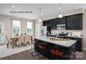 Eat-in kitchen with island seating and modern cabinetry at 2517 Ellen Ave # 1015C, Charlotte, NC 28208