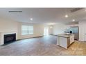 Open living room with hardwood floors, fireplace, and kitchen island at 854 Two Brothers Ln, York, SC 29745