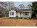 Charming white house with a covered porch, landscaping, and a spacious yard at 333 W Wilson Ave, Mooresville, NC 28115