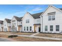 Row of townhouses with white exteriors, landscaping, and black doors at 380 Bly St, Rock Hill, SC 29732