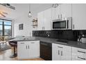 Sleek kitchen with black tile backsplash and stainless steel appliances at 514 W 10Th St # 302, Charlotte, NC 28202