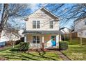 Charming two-story home with a blue door and porch at 7613 Rolling Meadows Ln, Huntersville, NC 28078