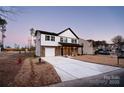 Two-story house with white and brown accents, a garage, and a well-manicured lawn at 904 Harbor Islands Ct, Gastonia, NC 28056