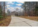 Long driveway leading to a two-story house at 123 Kingfisher Dr, Mooresville, NC 28117