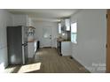 Modern kitchen with white cabinets and stainless steel appliances at 208 Nila Dawn Ave, Gastonia, NC 28052
