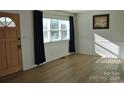 Bright living room featuring hardwood floors and large windows at 208 Nila Dawn Ave, Gastonia, NC 28052