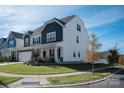 Two-story home with white and blue siding, stone accents, and a landscaped yard at 2547 Bullfrog Ln, Lancaster, SC 29720