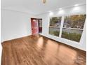 Bright living room with hardwood floors and a view to the backyard at 2823 Edsel Pl, Charlotte, NC 28205