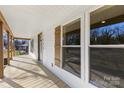 Inviting front porch with wood flooring and stylish shutters at 1024 8Th St, Statesville, NC 28677