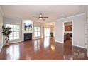 Spacious living room with hardwood floors, fireplace, and open floor plan at 16806 Dunaverty Pl, Charlotte, NC 28277