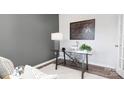 Home office with glass desk, gray walls, and periodic table print at 5145 Fireweed Ct, Dallas, NC 28034
