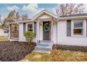 Front entrance of a cozy white house with black door and shutters at 364 Scotts Creek Rd, Statesville, NC 28625