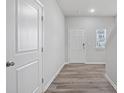 Bright entryway with wood-look flooring and neutral wall colors at 8209 Stonemere Ln, Charlotte, NC 28215