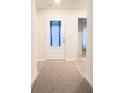 Bright and airy entryway with neutral colors and a modern door at 1401 Nia Rd, Charlotte, NC 28215
