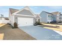 Gray house with white garage door and driveway, next to similar house at 1827 Ashley-Lynn Ct, Stanfield, NC 28163