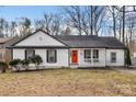 House exterior with white siding, red door, and landscaping at 1919 Crooked Creek Dr, Charlotte, NC 28214