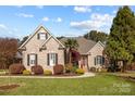 Brick home with palm tree and landscaped yard at 5422 Glen Forest Dr, Charlotte, NC 28226