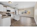 Kitchen with white cabinets, granite countertops, and stainless steel appliances at 8014 Bryson Rd, Fort Mill, SC 29707