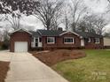 Brick ranch home with attached garage and landscaped yard at 936 N 5Th St, Albemarle, NC 28001