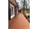Red brick home with a long tiled side porch at 936 N 5Th St, Albemarle, NC 28001