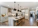 Modern kitchen with white cabinets, island, and stainless steel appliances at 5124 Heathland Dr # 78, Charlotte, NC 28215