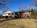 Side view of a brick ranch house with a spacious lawn at 604 Eastwood Dr, Albemarle, NC 28001