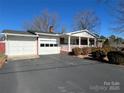 Front view of a ranch house with a carport and landscaping at 604 Eastwood Dr, Albemarle, NC 28001