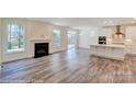 Open kitchen with white cabinets, island, and stainless steel appliances at 2024 Embassy Ct # 49, Charlotte, NC 28213