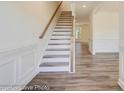 Modern staircase with white risers and wooden handrail at 2024 Embassy Ct # 49, Charlotte, NC 28213