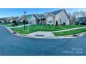 Two-story home with gray siding, stone accents, and a landscaped lawn at 3100 Glacier Ct, Gastonia, NC 28056
