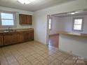 Kitchen features wood cabinets and tile floors at 683 Sweeney St, Chester, SC 29706