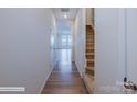 Light hallway featuring stairs and wood-look floors at 2735 Winn Mill Dr # 49, Gastonia, NC 28056