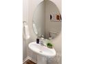 Stylish bathroom featuring a pedestal sink and round mirror at 5063 Beargrass Dr, Dallas, NC 28034