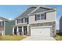 Two-story house with gray siding, stone accents, and a two-car garage at 7894 Old Brook Rd, Sherrills Ford, NC 28673