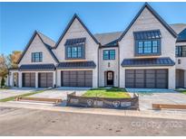 Modern townhome with 3-car garage and neutral brick exterior at 401 Audrey Pl # 3, Charlotte, NC 28226