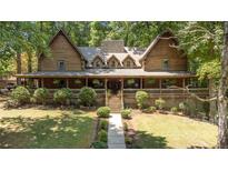 Stunning log home with wrap-around porch and landscaped yard at 6255 Meadow Ln, Salisbury, NC 28147