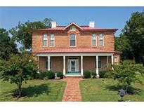 Brick house with a metal roof and front porch at 318 Camden Rd, Wadesboro, NC 28170