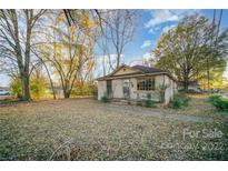 Brick ranch home with mature trees and lawn at 2607 N Main St, Kannapolis, NC 28081