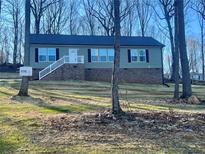 Ranch style home with brick foundation and wooded lot at 5748 Dalmatian St, Iron Station, NC 28080