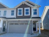 Two-story townhome with gray siding, stone accents, and a two-car garage at 5645 De Vere Dr # 103 Blayre, Indian Land, SC 29707